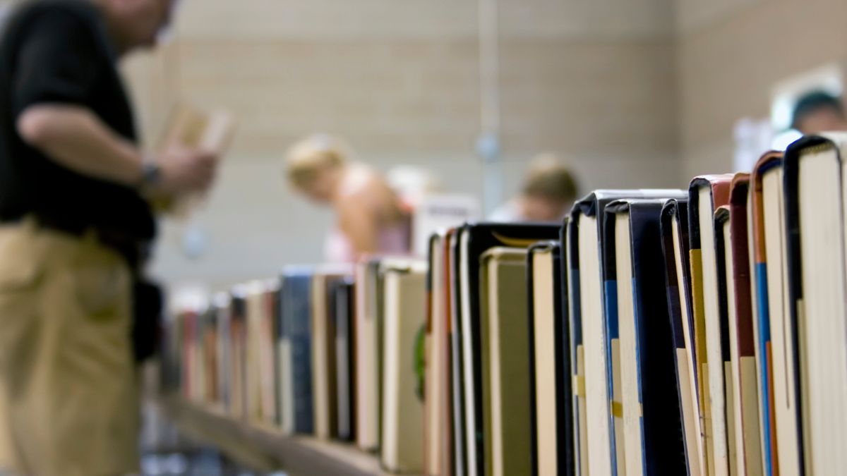 Used book sale with blurred people on the background