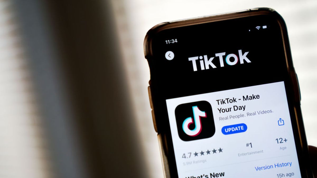 A phone with the App Store download page for TikTok open.