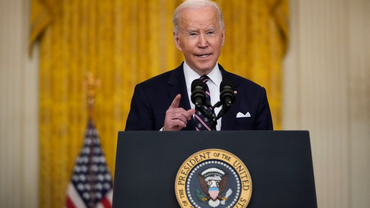 President Joe Biden speaks at podium.