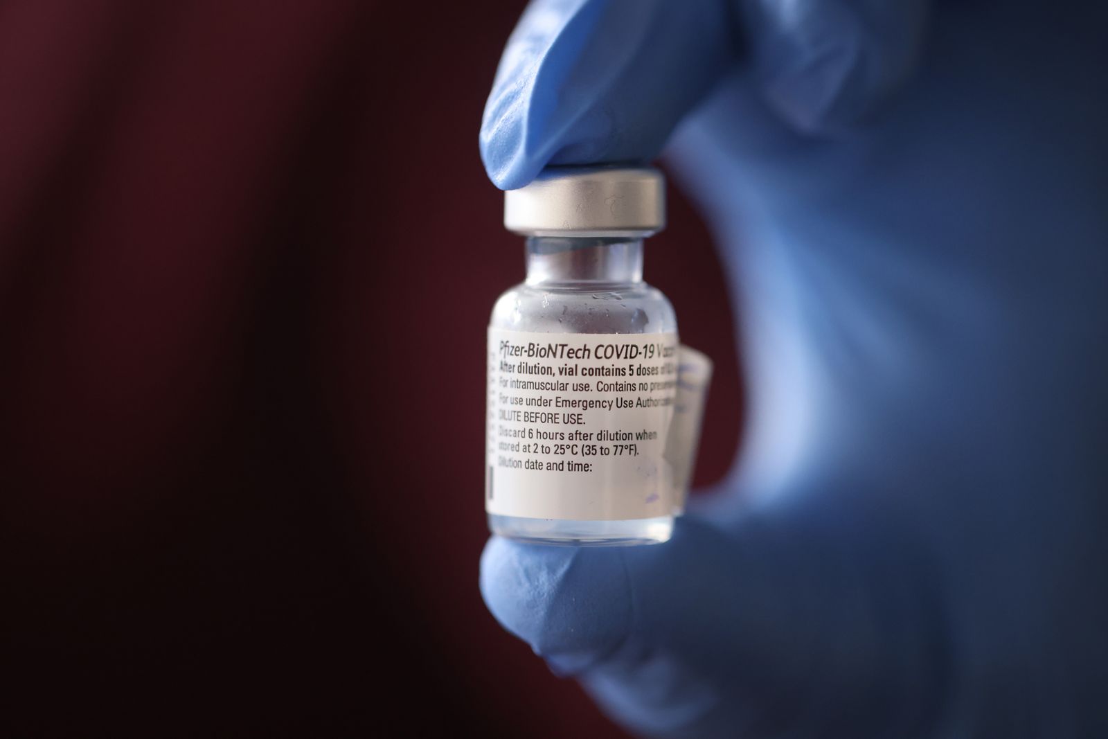 A nurse shows a container of Pfizer-BioNTech COVID-19 vaccine after it was used to vaccinate the first five staff members at Roseland Community Hospital on December 17, 2020 in Chicago, Illinois.