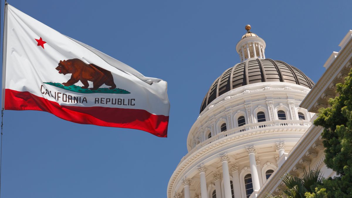 California state flag and state capitol building in Sacramento